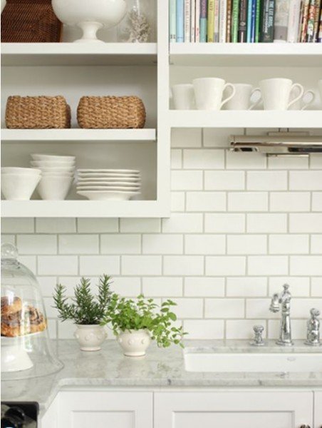 kitchen close up backsplash white subway tiles dark grey grout open shelving shelves marble countertops white cabinets