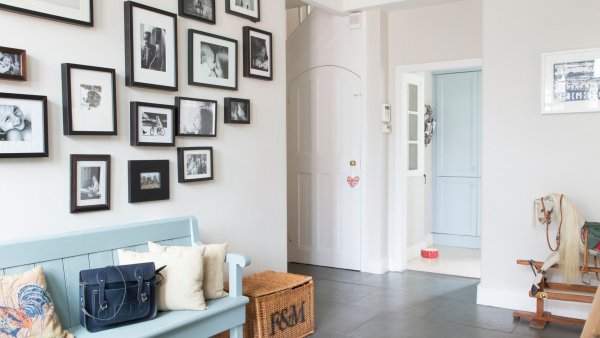 Hallway-with-painted-bench-and-family-photo-wall