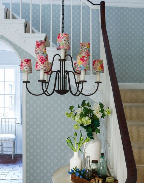 Pale-blue-country-hallway-with-oversized-chandelier