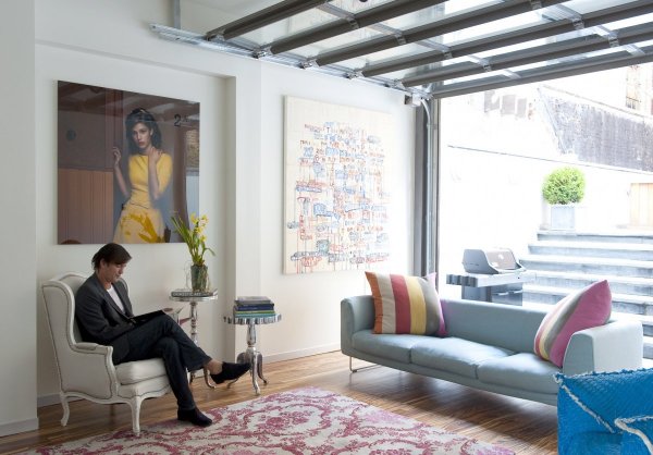 the-coolest-part-of-the-room-is-that-the-floor-to-ceiling-windows-are-actually-a-moveable-garage-door-that-opens-out-onto-the-homes-garden-area